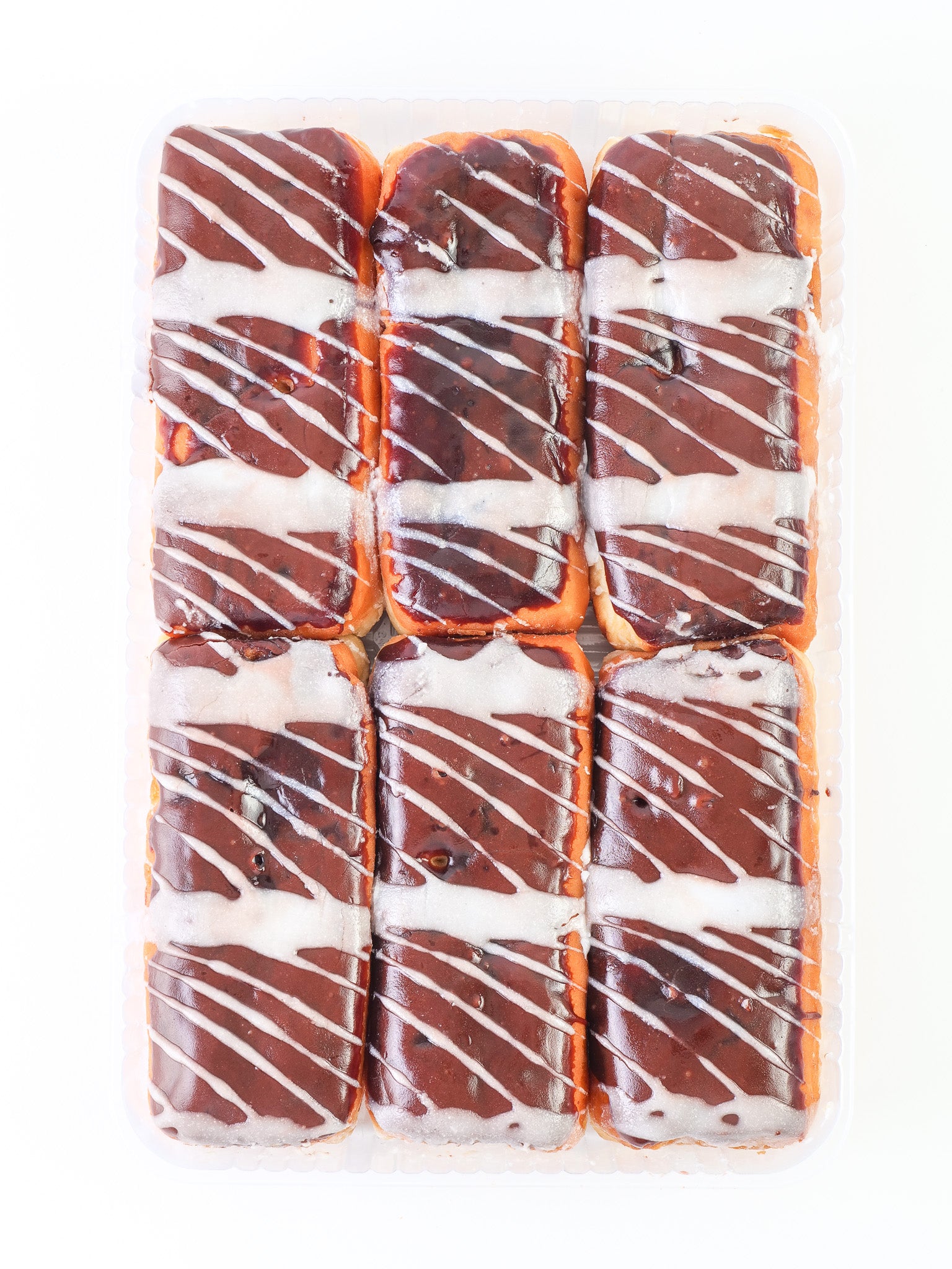 Chocolate Iced Custard Filled Long John with White Drizzle