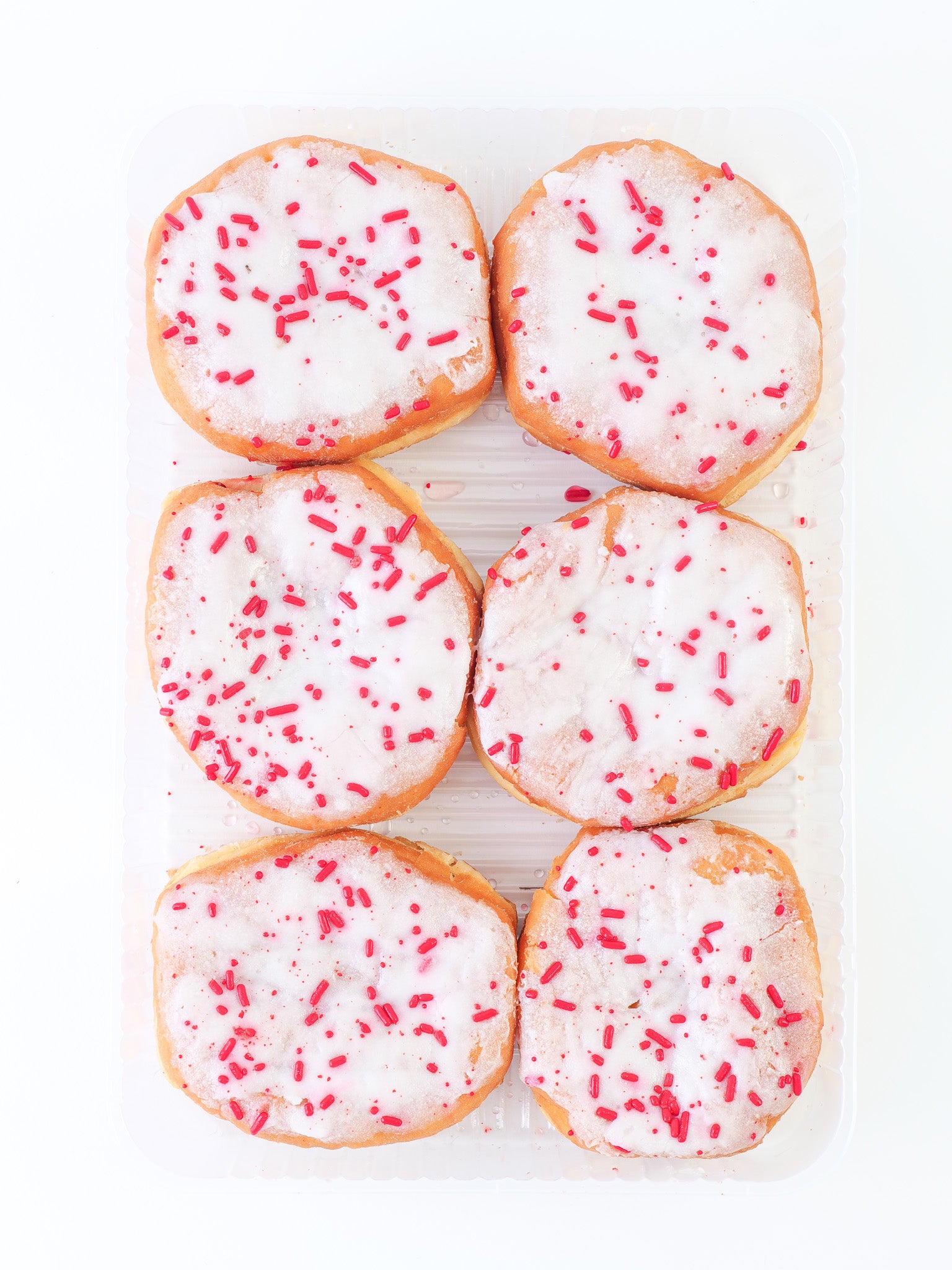 White Iced Raspberry Filled Bismarck with Red Sprinkles